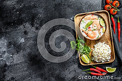 Tom Kha Gai. Spicy creamy coconut soup with chicken and shrimp. Thai food. Black background. Top view. Copy space Stock Photo