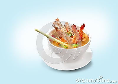 Tom Yam Kung Shrimp in a white bowl with Thai spices on a plate. Stock Photo