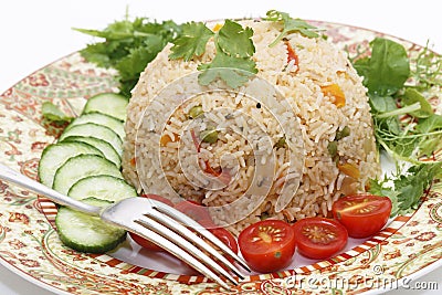 Tomato biryani and fork Stock Photo