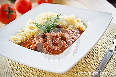 Tomato curry with couscous Stock Photo