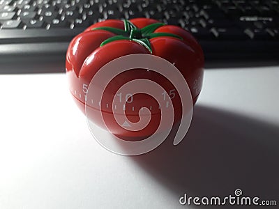 Pomodoro timer - mechanical tomato shaped kitchen timer for cooking or studying Stock Photo