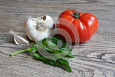 Tomato, Garlic and Basic on Wood Table Stock Photo