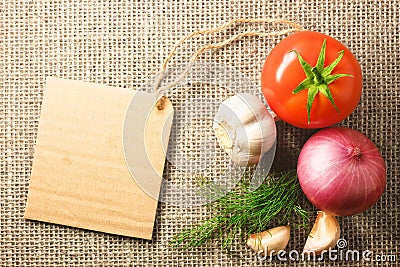 Tomato onion and garlic vegetables and price tag on sacking back Stock Photo