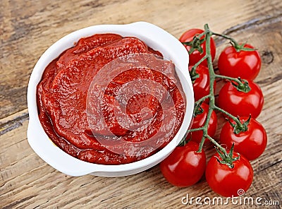 Tomato paste with ripe tomatoes Stock Photo