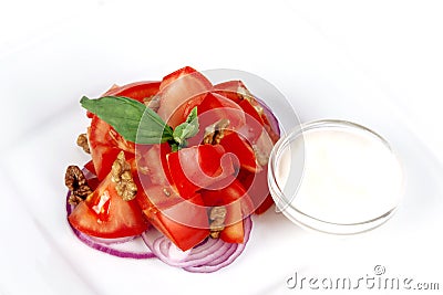 Tomato salad with basil, red onion and sour cream Stock Photo