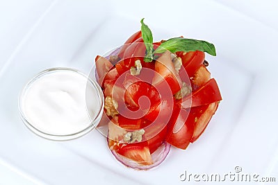 Tomato salad with basil, red onion and sour cream Stock Photo