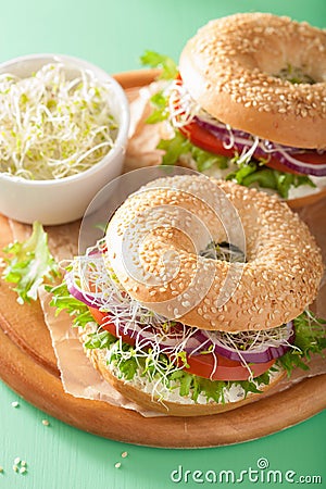 Tomato sandwich on bagel with cream cheese onion lettuce alfalfa Stock Photo