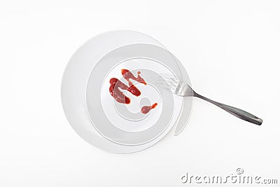 Tomato sauce, ketchup on white ceramic plate with a fork isolated on white, tasty dinner or lunch is over, concept of Stock Photo