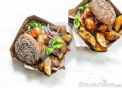 Tomato sauce meatballs mozzarella cheese whole grain buns burgers and baked potatoes on a light background, top view Stock Photo