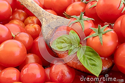 Tomato sauce on wooden spoon with cherry tomatoes and basil on background with tomatoes. Isolated photo Italian cuisine pasta Stock Photo