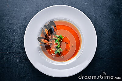 Tomato and seafood creamy soup with mussels. Stock Photo