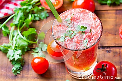 Tomato smoothie, fresh tomatoes and cilantro on wooden background Stock Photo