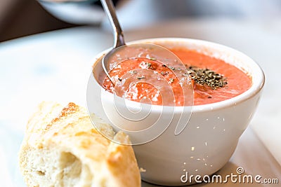 Tomato soup with spoon and bread Stock Photo
