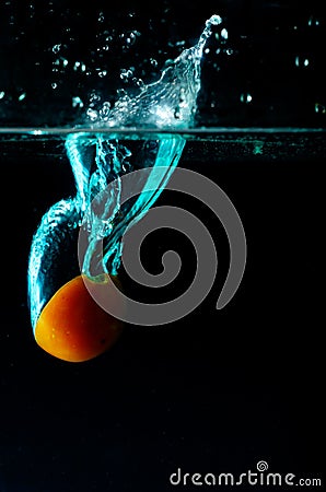 Tomato water splash on black background Stock Photo