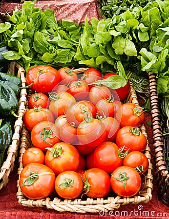 Tomatoes and basil on display in baskets Stock Photo