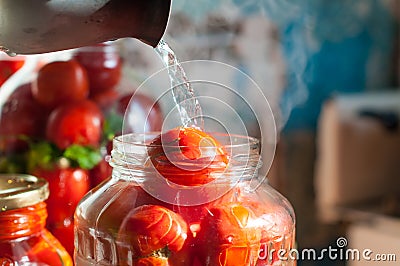 Tomatoes being swamped boiled water in process of Stock Photo