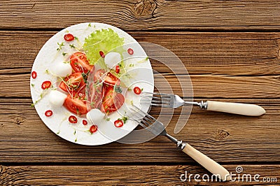 Tomatoes, chili pepper, mozarella and watercress salad in white Stock Photo