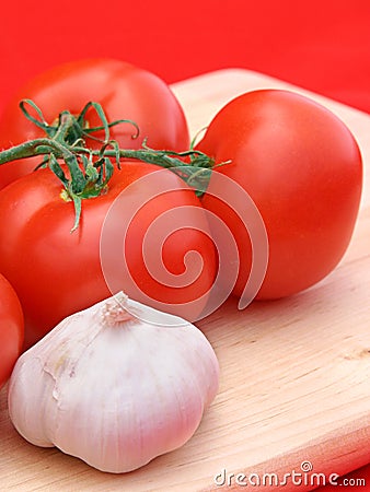 Tomatoes & Garlic on Red Stock Photo