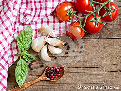 Tomatoes, mint, garlic and pepper on dark wood and dish towel Stock Photo