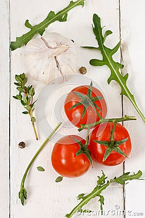 Tomatoes, rucola, garlic and thyme. Stock Photo