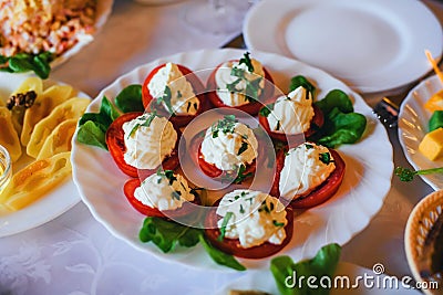 Tomatoes with sauce on a plate for snacks Stock Photo