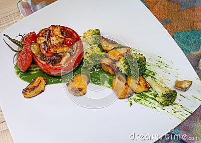 Tomatoes stuffed with vegetables and chicken Stock Photo