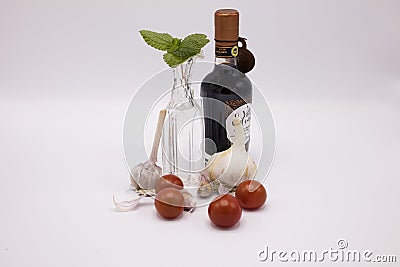 Tomatoes with vinegar and garlic on the table. Stock Photo