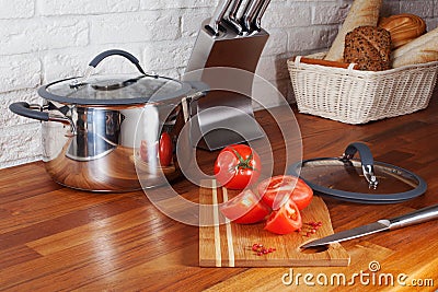 Tomatoes on a wooden board knife kitchen countertops, interior, pan, hob, cooker Stock Photo