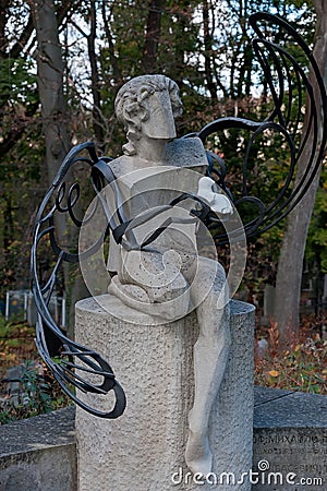 Tomb sculpture of a angel with dove on a gravestone Stock Photo