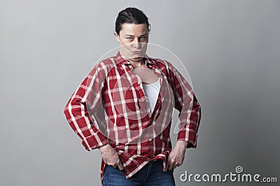 Tomboy mature woman standing with wide shoulders impressing Stock Photo