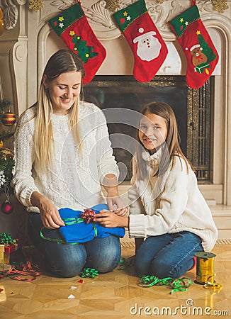 Toned portrait of smiling girl with mother packing pullover in p Stock Photo