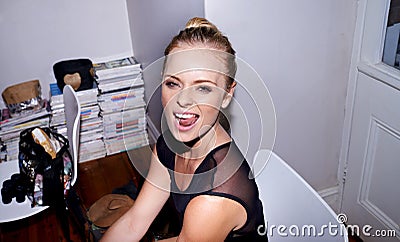 Tongue, funny and playful portrait of woman in home for comic with goofy expression or good moody with crazy face Stock Photo