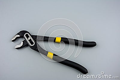 Tongue-and-groove slip-joint pliers detail with movable jaw on a white background Stock Photo