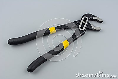 Tongue-and-groove slip-joint pliers detail with movable jaw on a white background Stock Photo