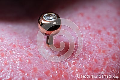 Tongue piercing and gold jewelry with a stone picture from the side Stock Photo