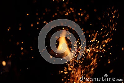 Tongues of flame and sparks in the dark Stock Photo