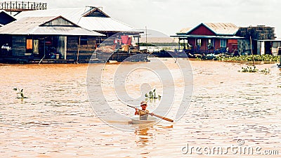 Cambodian boy use basin as a boat Editorial Stock Photo