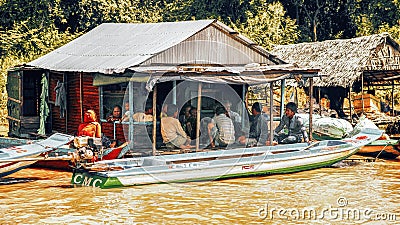 Family meeting in a house on a floating village on Tonle Sap lake Editorial Stock Photo