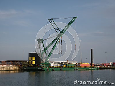 The 250 tonne crane Skylift 2 operating on the submersible Skyline Barge 26 while lifting equipment at docks in Birkenhead Editorial Stock Photo