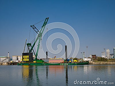 The 250 tonne crane Skylift 2 operating on the submersible Skyline Barge 26 while lifting equipment at docks in Birkenhead Editorial Stock Photo