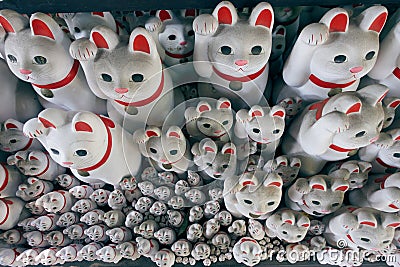 Tons of small dolls `the beckoning cat` known as maneki neko Editorial Stock Photo