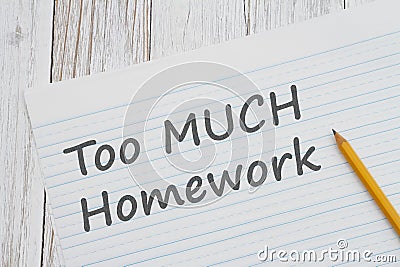Too much Homework message on ruled lined paper with pencil for school Stock Photo