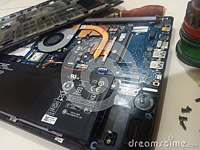 took apart the laptop for repair, added ram, and cleaned the fan and motherboard Editorial Stock Photo