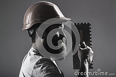 Tool, trowel, handyman, man builder. Mason tools, builder. Bearded man worker, beard, building helmet, hard hat Stock Photo