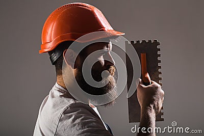 Tool, trowel, handyman, man builder. Mason tools, builder. Builders in hard hat, helmet. Bearded man worker, beard Stock Photo