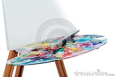 Tools of the artist. Brushes, wooden easel tripod, palette colorful. white background, studio, nobody. isolated Stock Photo