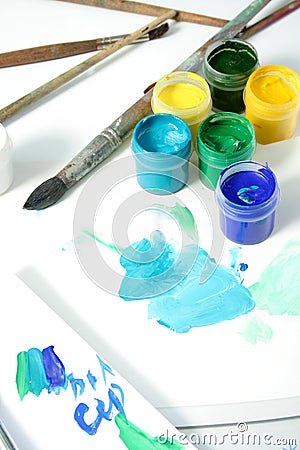 Tools of the artist: paints, brushes and a paper Stock Photo