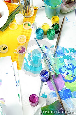 Tools of the artist: paints, brushes and a paper Stock Photo