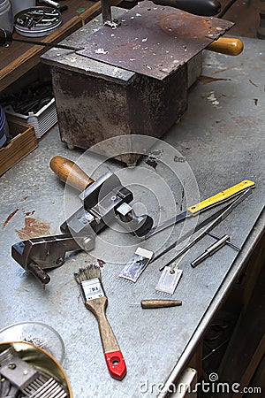 Tools, components and finished mold lie on a bench in the handcraft. Stock Photo