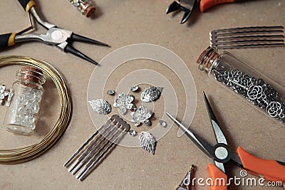 Tools for creating jewelry. Beads, crystals, glass bottles with cork lids, hair combs. Wire, cutters, pliers Stock Photo